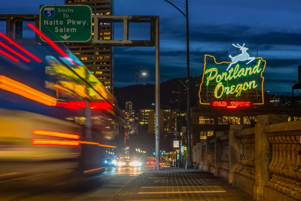 Portland Oregon Old Town neon sign and blurred traffic at night.